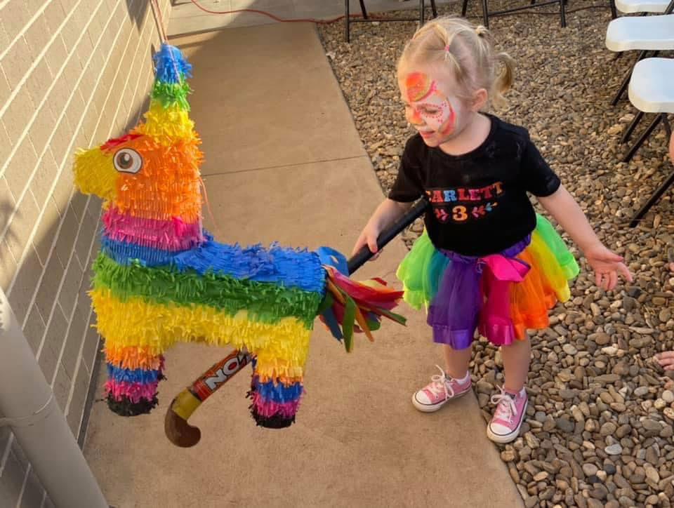 Coco theme party birthday celebrant with a pinata