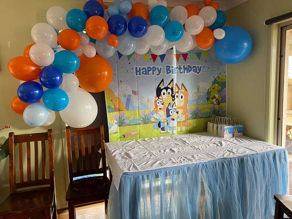 Bluey party table set up and balloon garland