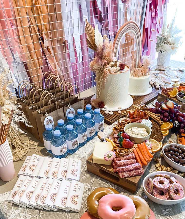 Boho rainbow party theme table set up with food