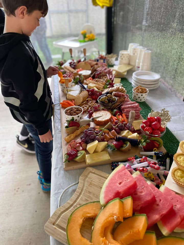 Grazing platter with boy getting food