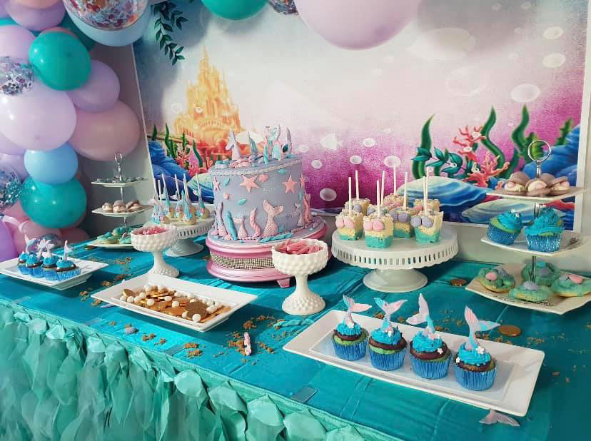 Mermaid party table filled with mermaid themed food