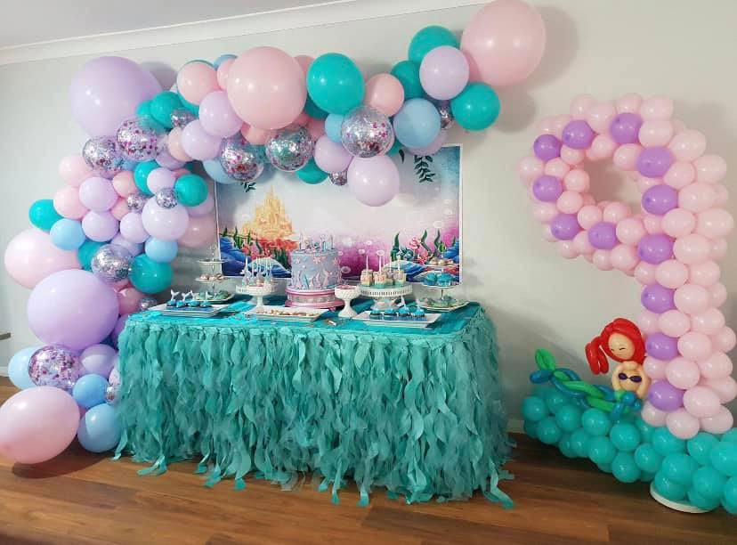 Mermaid theme party table set up with balloons