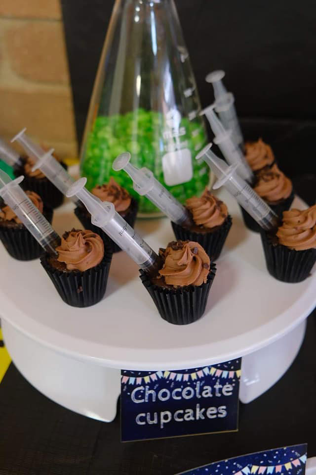 Science theme party cupcakes with syringes on top