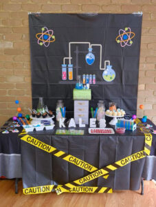 Science theme party table set up with backdrop