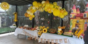 Sunflower Theme party table with balloon garland