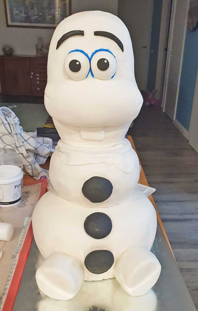 Top and head of Olaf birthday cake