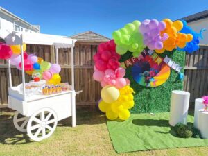 Trolls party theme set up beside the backdrop
