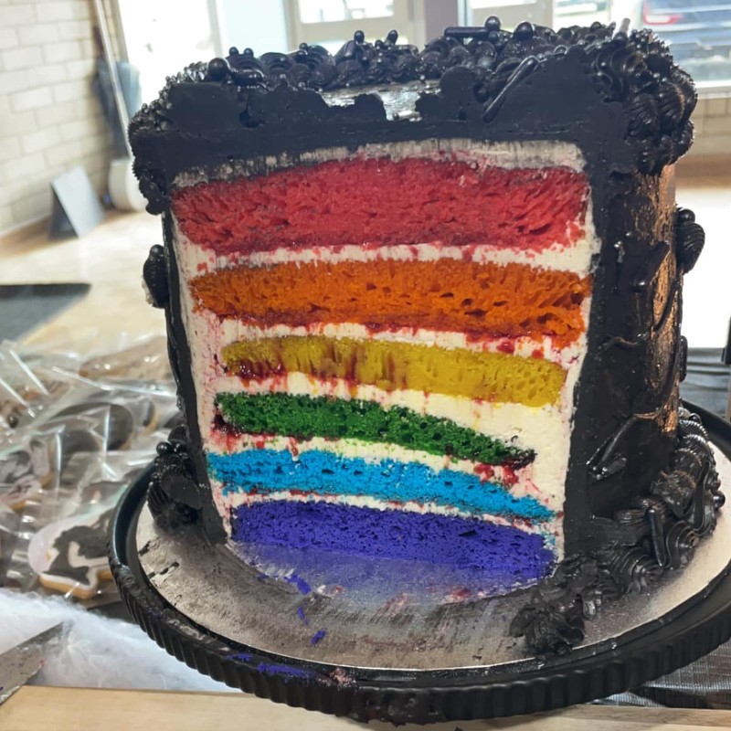 Wednesday-themed rainbow birthday cake.